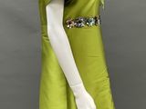 an image of a mannequin wearing a green dress with sequins on it