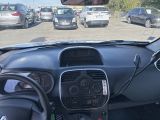 many cars parked in a parking lot behind a car