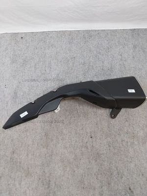 a close up of a black motorcycle handle on a carpet