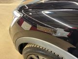 a close up of a car ' s tail light on the hood