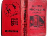 an old red book with a picture of a man in a boxing glove
