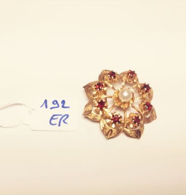 an image of a gold brooch with garnets and pearls