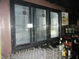 a bar with a bunch of empty glasses on the counter