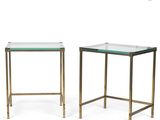 a pair of brass and glass side tables