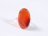 a red agite stone ring with a gold band