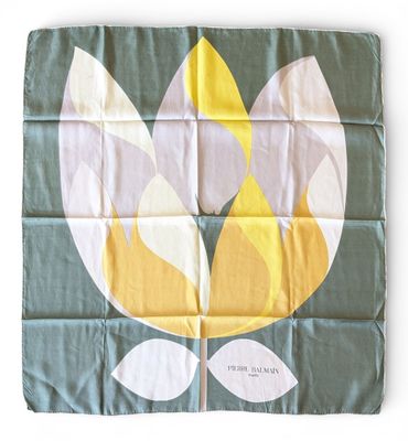 a flag with a flower on it on a white background