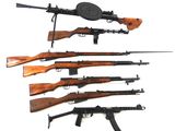 several different types of guns are lined up on a white surface