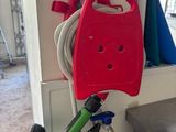 a red hose attached to a green and black hose