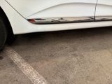 a white car that is parked in a parking lot