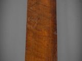 an old wooden sign hanging on a wall in a room