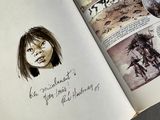 an open book with a drawing of a woman on it