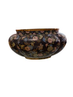 a vase that is sitting on a stand on a white surface