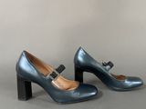 pair of women ' s blue heels with a bow on the heel