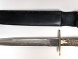 a knife that is laying next to a knife on a table