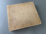 an old book sitting on top of a table next to a blue table