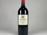 the bottle of red wine is sitting on the table