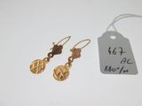 a close up of a pair of earrings with a price tag