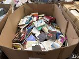 a cardboard box full of books in the middle of a room