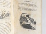 an open book with a picture of a man in a boat