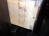 a wooden cabinet with a door that has some rust on it