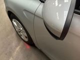 a side view mirror of a car on the side of the road