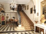 an image of a foyer with a staircase and a chandelier