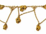 a close up of a gold chain bracelet with charms on it