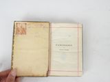 someone is holding a book open on a white surface