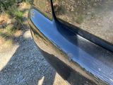 a close up of a car ' s bumper with a cat on it