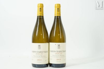 two bottles of white wine sitting next to each other on a table