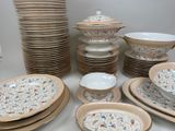 many plates and bowls that are stacked together on the table