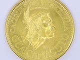 an image of a close up of a gold coin with a woman ' s face