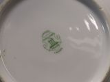 a white plate with a green design on it