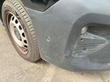 a close up of the front bumper of a car that has been dented