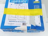 a box of toilet paper on a table with a sticker