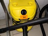 a yellow blow dryer sitting on the floor next to a black hose