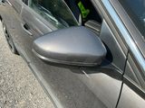 a close up of a car ' s side mirror on the side of the road