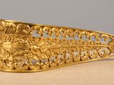 an image of a gold plated brooch with a design on it