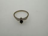 a silver ring with a black stone on top of it