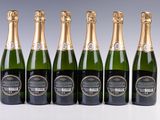 six bottles of champagne are lined up in a row