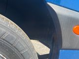 a close up of a tire on a blue truck