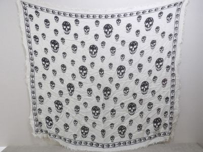 a black and white skull print scarf hanging on a wall