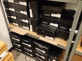 boxes are stacked on a shelf in a room with a lot of shelves