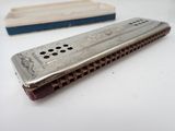 a harmonica that is sitting on a table next to a box