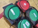 several green and red traffic lights sitting on top of a wooden floor