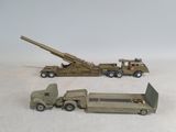 two toy army vehicles and a truck with a gun on the back