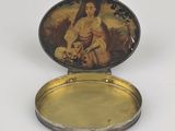 a small metal box with a picture of a woman on it