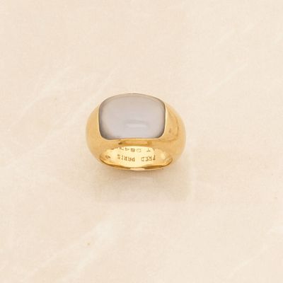 an image of a gold ring with a white stone