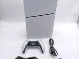a video game console and a game controller on a white table