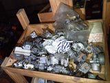 a wooden box filled with assorted motor parts